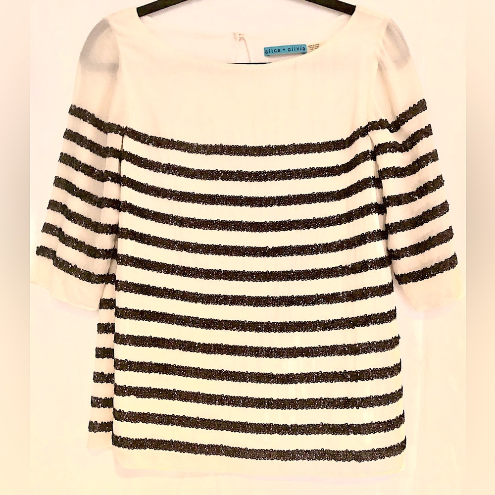 Alice + Olivia cream colored top with black sequin stripes. Like new condition